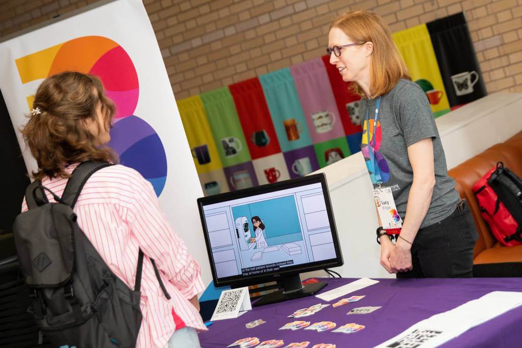 Lucy chatting with a conference attendee at our booth.